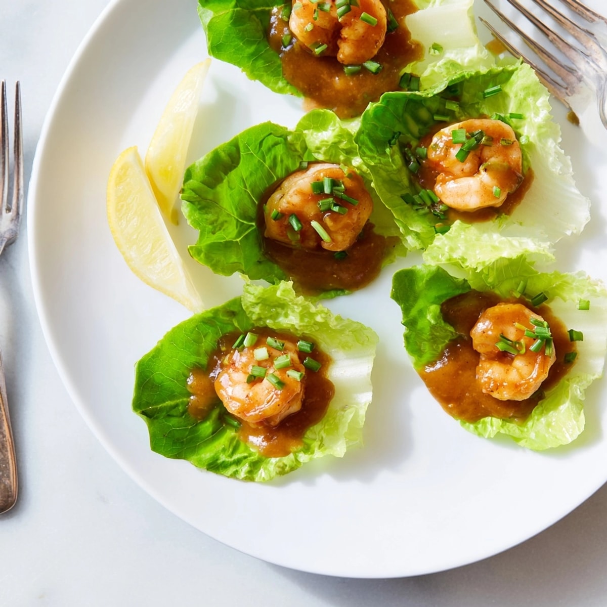 Festive shrimp cocktail cups recipe: Individual lettuce cups filled with the classic appetizer, ready to serve.