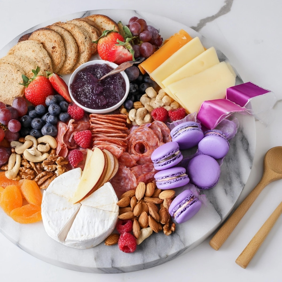 A colorful Charcuterie Board with Ube Macarons; savory meats meet sweet purple yams.