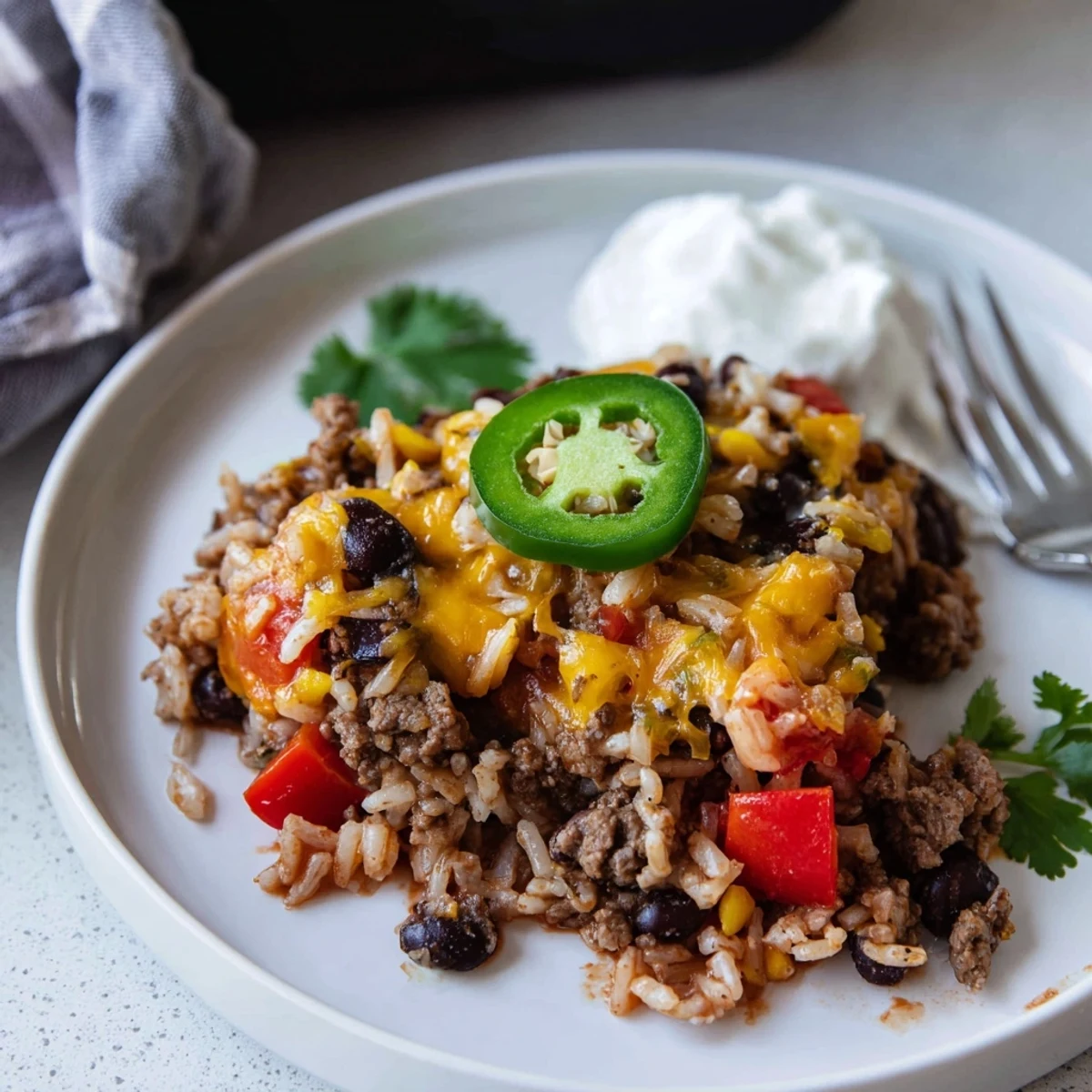 Comforting Tex-Mex Beef & Rice Casserole served warm with fresh cilantro garnish.