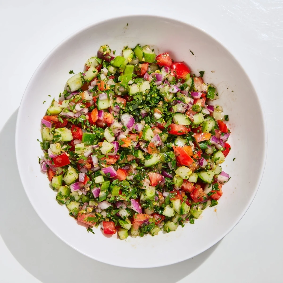 Vibrant Pickle De Gallo salsa with fresh cilantro and lime, ready to scoop with crispy tortilla chips.