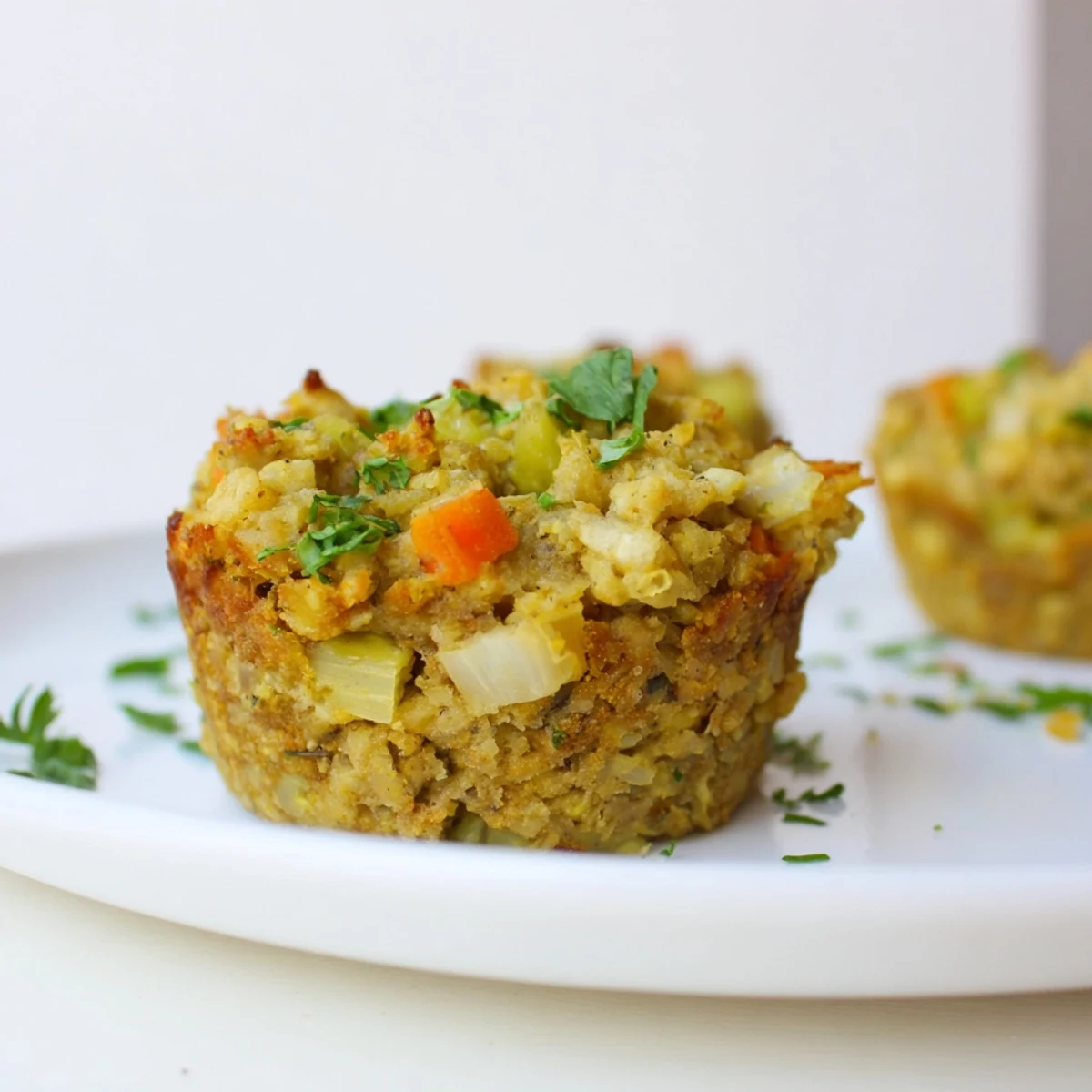 Warm, appetizing Vegan Chickpea Stuffing Muffins, a hearty vegan side, with visible herbs and vegetable pieces.