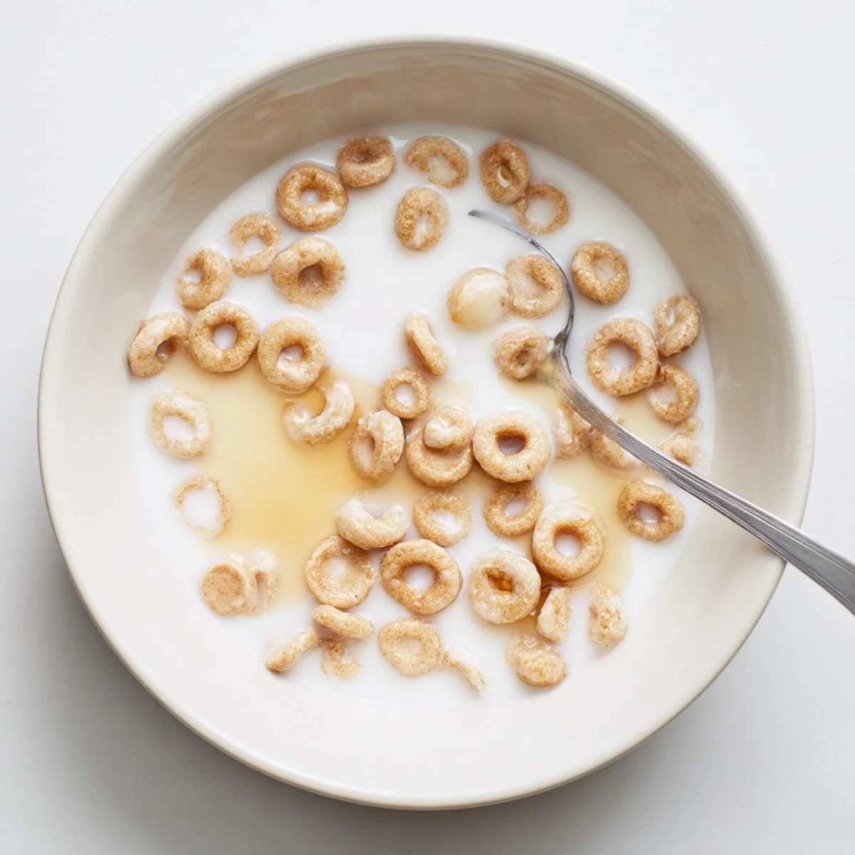 Tiny golden Pancake Cereal, served in a bowl, perfect with milk for a fun breakfast.
