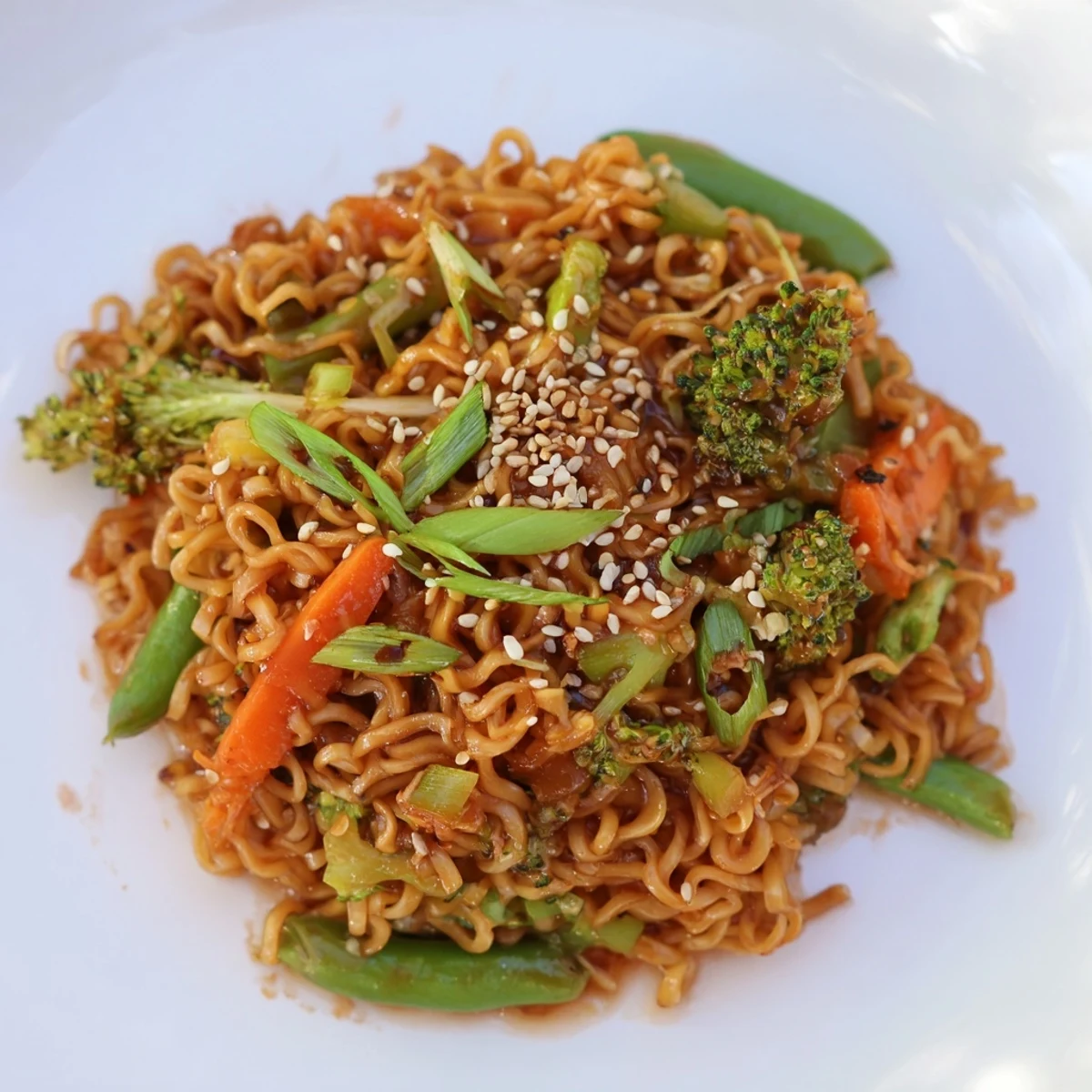 Golden ramen noodles in a skillet with a vibrant Ramen Noodle Stir-Fry Remix, ready to serve and enjoy.