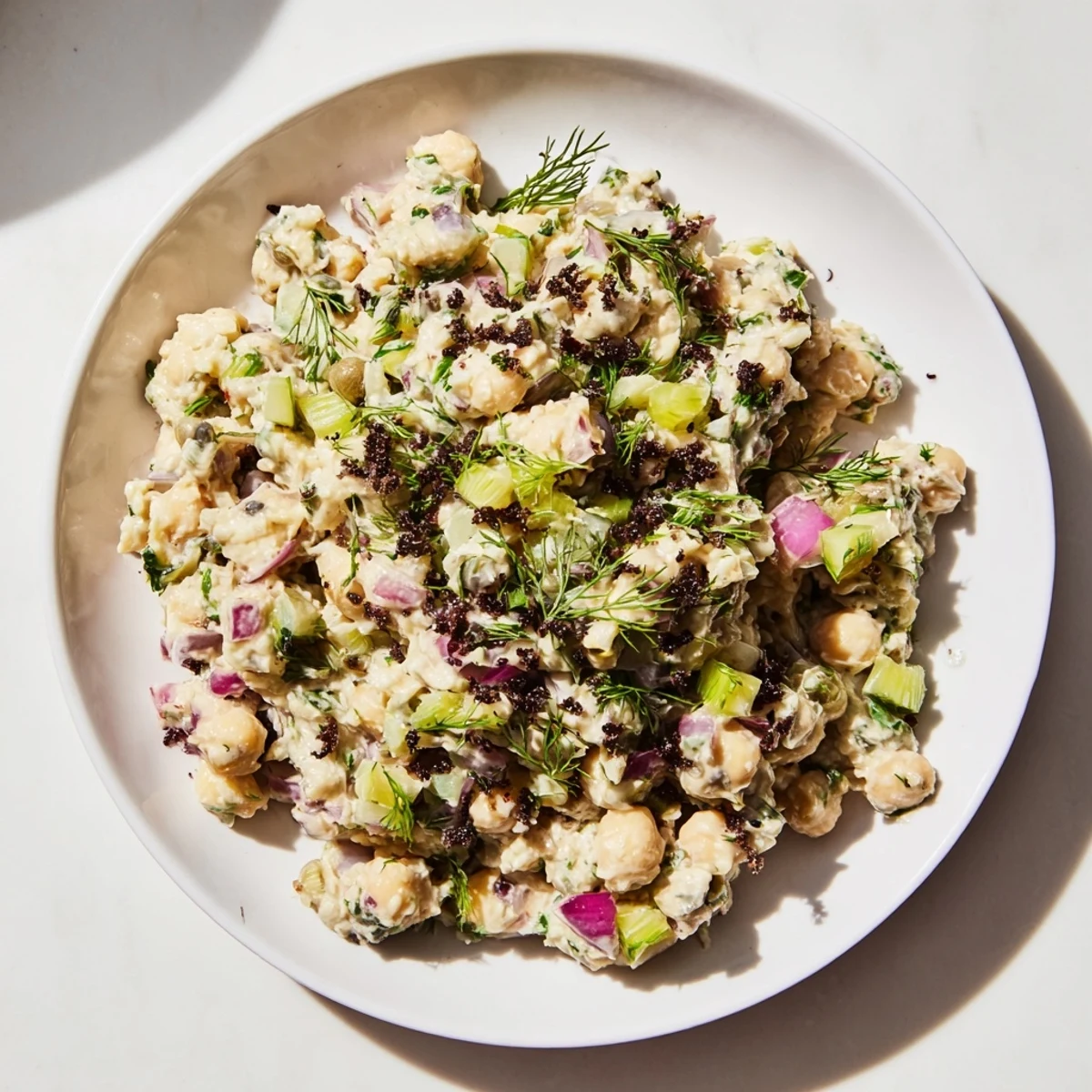 Plant-based chickpea tuna salad served, offering a healthy and flavorful alternative to tuna.