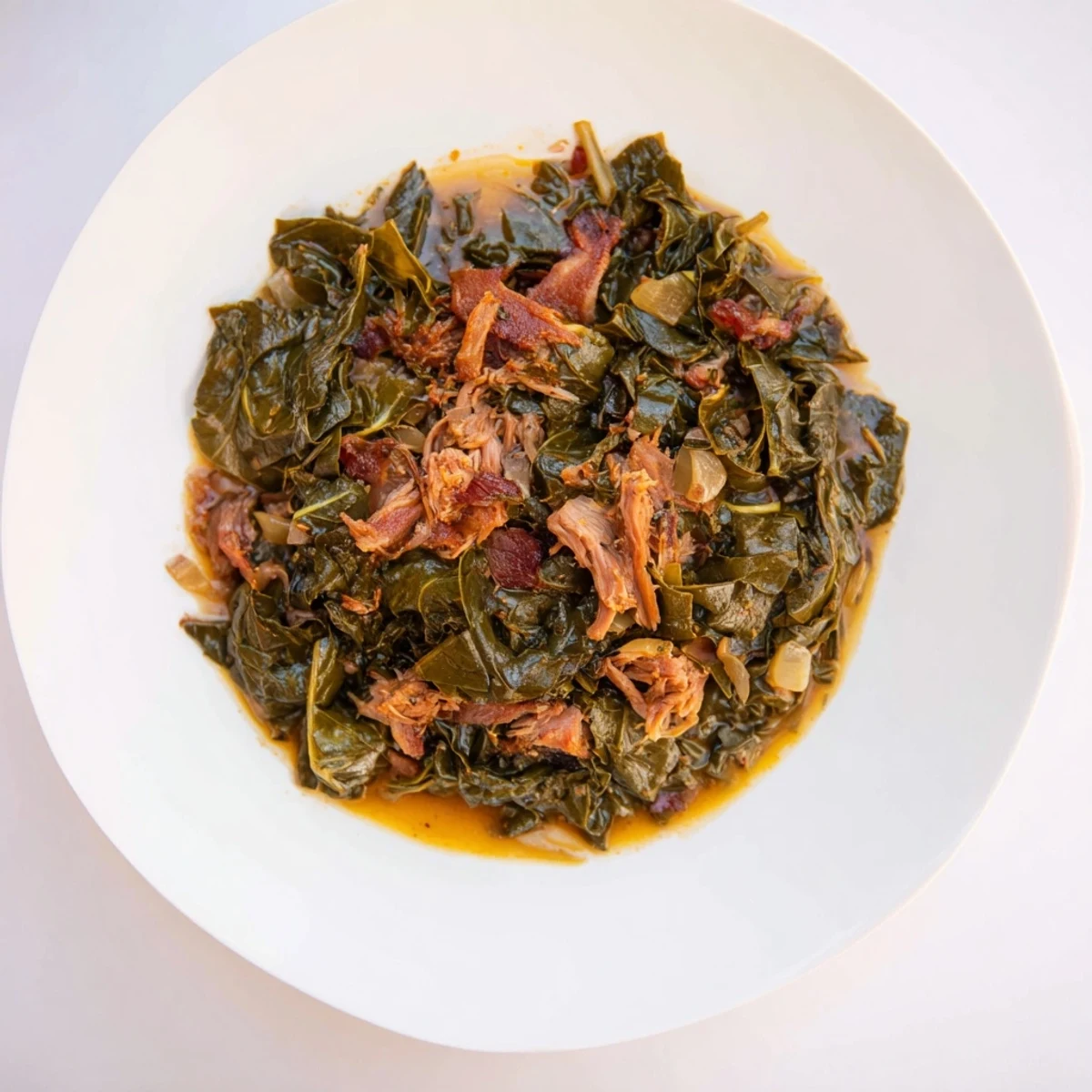 Hearty Southern style collard greens, simmered until tender, with savory smoked turkey visible in the pot.