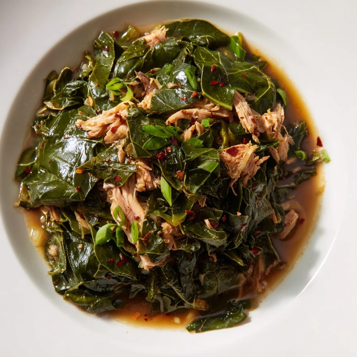 Golden Southern style collard greens with shredded turkey, perfect for a cozy, delicious Southern meal.