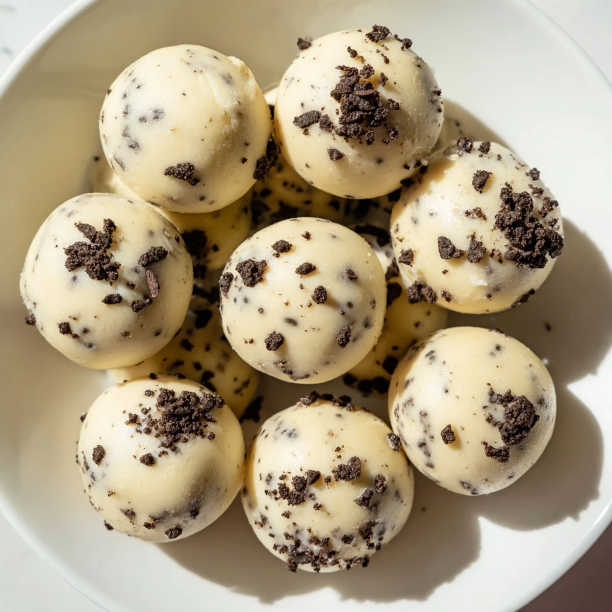Cream Cheese Oreo Protein Balls: creamy, bite-sized treats with visible Oreo cookie crumbs, ideal for snacking.