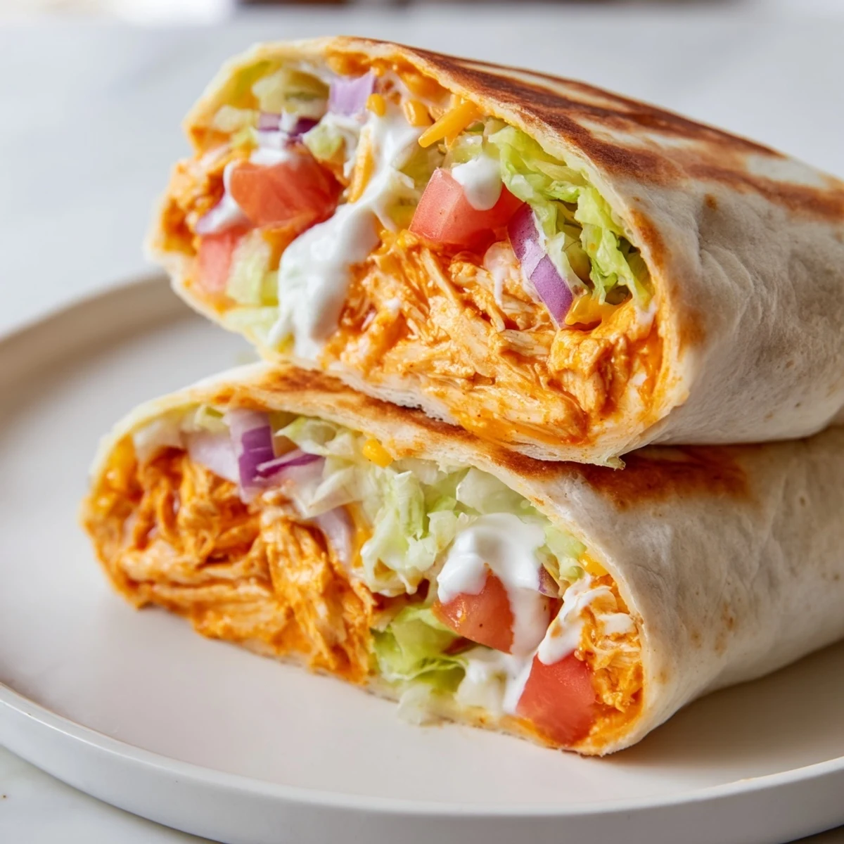Golden-brown Buffalo Chicken Wrap, packed with spicy chicken and fresh veggies, ready to eat.