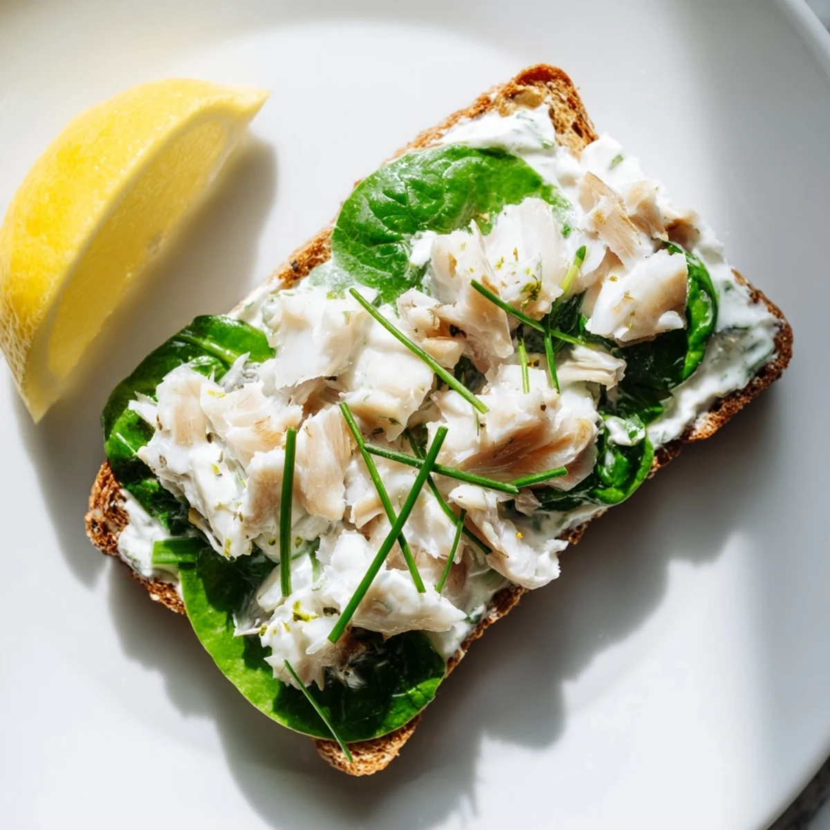 Hearty smoked haddock and spinach rye toasts on a rustic plate, a protein-packed breakfast ready to enjoy with coffee.
