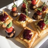 A party-ready Joy to the World Festive Appetizer Trio presenting colorful skewers, mini meatballs, and flaky pastries to enjoy!
