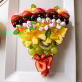 A visually appealing slice of Happy Birthday Cake Slice Fruit Board brimming with fresh, healthy fruits for snacking.
