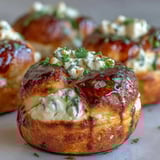 Golden-brown Hot Honey Ricotta Stuffed Garlic Knots, fresh from the oven, drizzled with spicy sweet glaze.