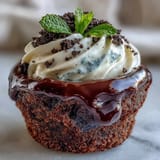 Rich chocolate brownies nestled in tiny pots, topped with creamy frosting and edible flowers.