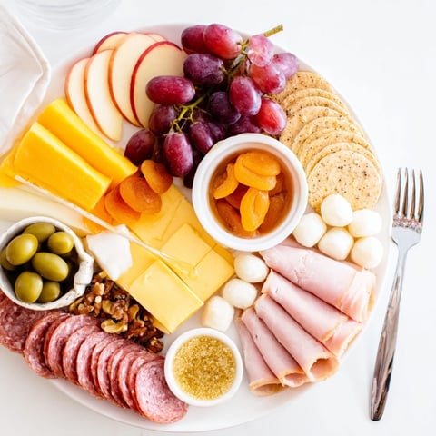 Enticing charcuterie board with sweet mochi donut holes, perfect for brunch gatherings.  