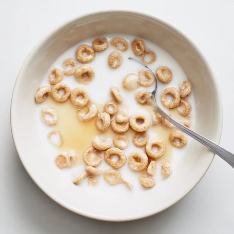 Tiny golden Pancake Cereal, served in a bowl, perfect with milk for a fun breakfast.