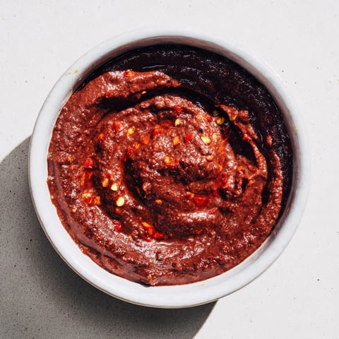 Smooth, vibrant Spicy Black Bean Dip; creamy texture perfect with crunchy tortilla chips for dipping.