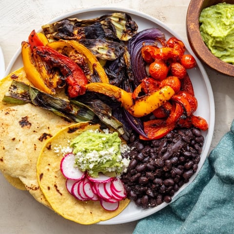 Image of a colorful Desert Bloom Cactus Taco Board, overflowing with vibrant toppings.