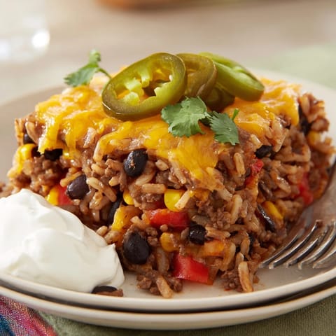 Delicious Tex-Mex Beef & Rice Casserole bubbling with melted cheese and spices.  