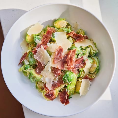 Sautéed Brussels sprouts star in this Caesar salad, topped with crispy prosciutto and creamy dressing.