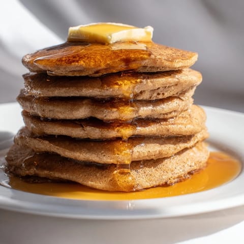 Warm, spiced gingerbread pancakes stacked high, perfect for a cozy, delicious brunch at home.