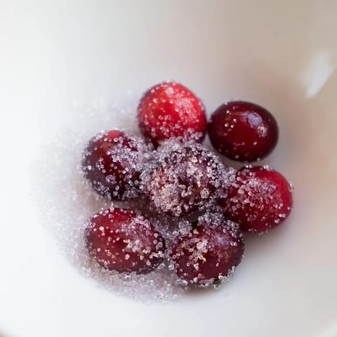 Vibrant red 5-Minute Express Candied Cranberries ready to eat, perfect for topping festive dishes.