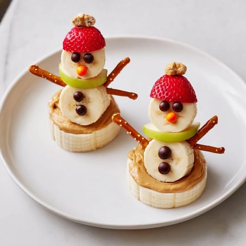 Homemade Banana Peanut Butter Snowmen are a cute, healthy, and festive treat for kids to enjoy.