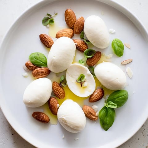 Imagine creamy cheeses and crunchy almonds in this "Polished Pebble" appetizer's stream-like design.