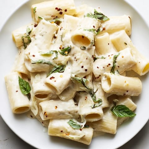A close-up of creamy cottage cheese pasta, showing the silky texture and savory sauce's creamy color.