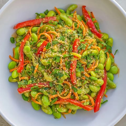A colorful serving of Asian Edamame Salad with sesame seeds adding a delightful crunch.