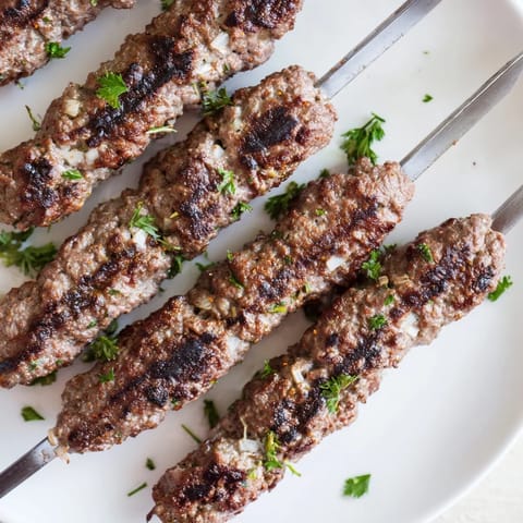 Deliciously seasoned Iraqi Kebab Tikka kebabs, perfectly grilled, offer a delightful aroma and savory flavors.