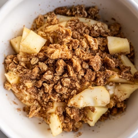 Classic pear crumble served warm in a baking dish, with tender fruit filling and a rustic crumble crust.