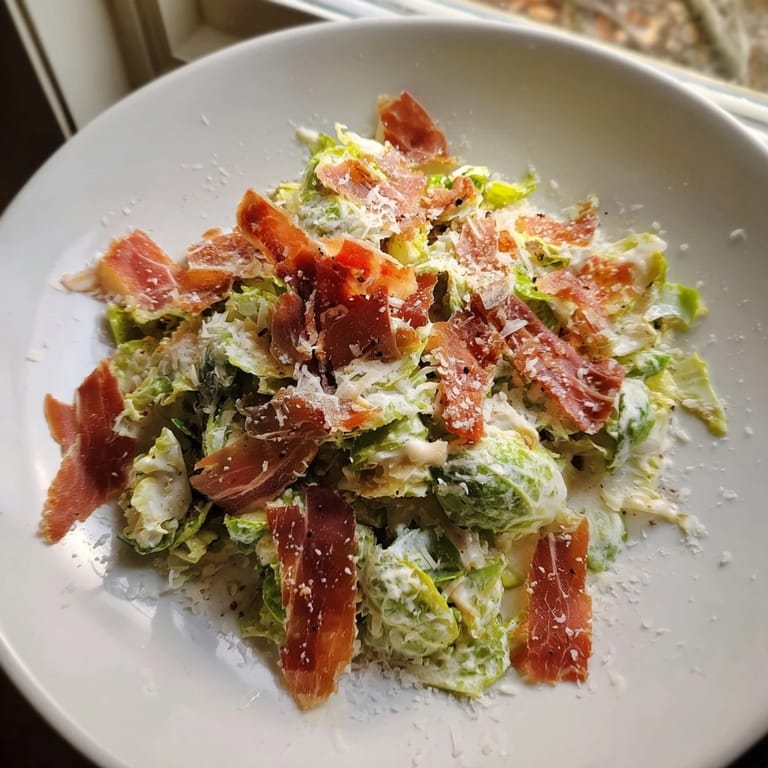 Enjoy this warm Brussels Sprouts Caesar, with golden sprouts, and salty prosciutto ready to eat.