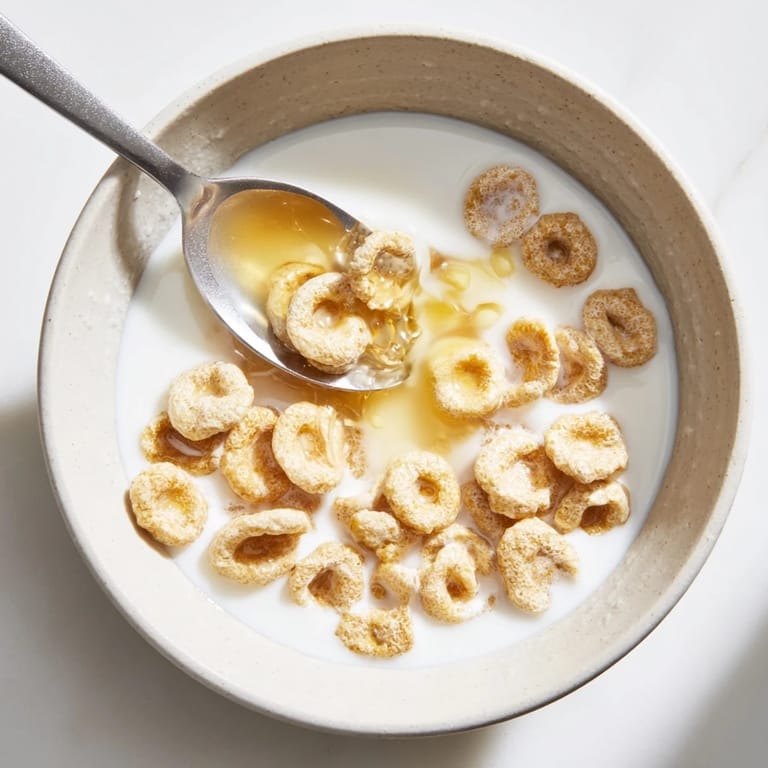 Close-up of adorable Pancake Cereal: miniature pancakes ready to be enjoyed with sweet syrup.