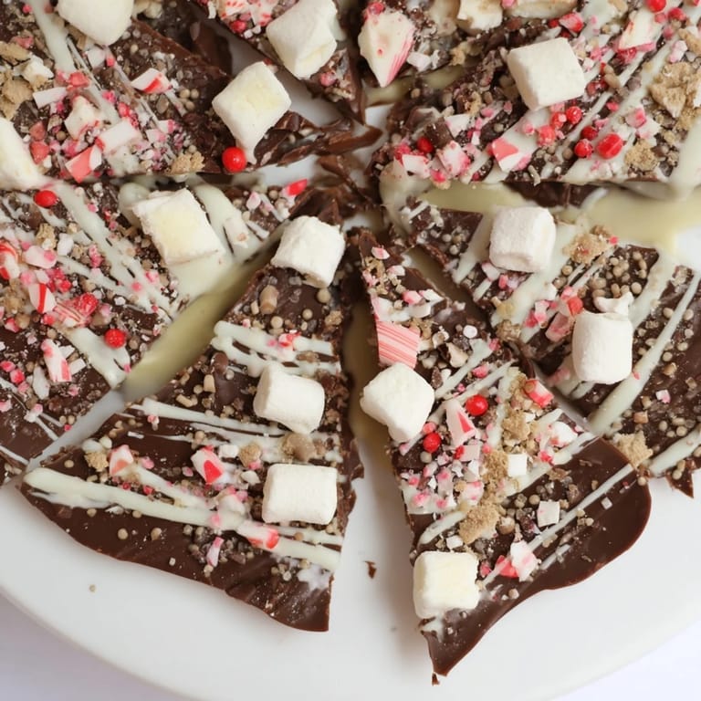 Deliciously rich hot chocolate bomb bark studded with creamy marshmallows and crunchy crushed peppermint candies.