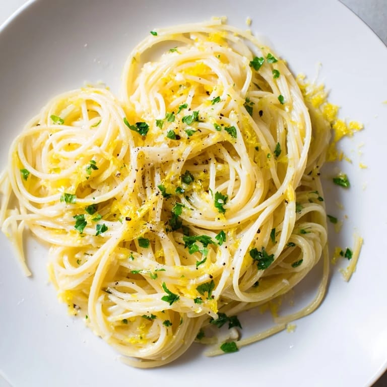 Golden strands of capellini coated in a luscious lemon butter sauce, the Lemon Butter Pasta Light.