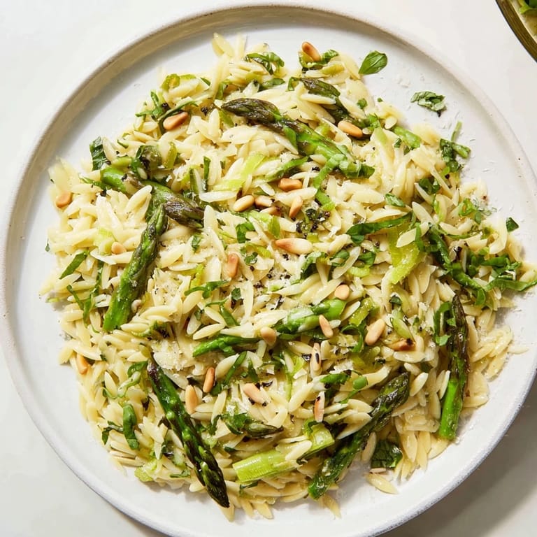 This delicious Asparagus Lemon Orzo Salad features glistening pasta and vibrant green asparagus tossed in lemon dressing.