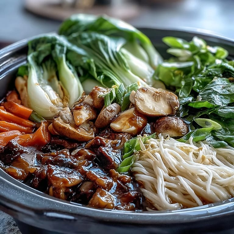 Steaming Asian Hot Pot broth with ginger and shiitake, featuring colorful veggies like snow peas and Napa cabbage ready for dipping.