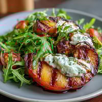 Grilled Peach and Burrata Salad with arugula, cherry tomatoes, and balsamic glaze for a summery vegetarian dish.