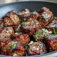 One-pan garlic herb steak bites with juicy seared sirloin and aromatic garlic butter, perfect for quick summer dinners.